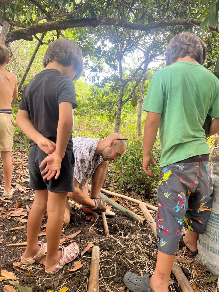 Davie and children working the soil at Blossom Forest School, Taino Farm